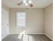 Neutral bedroom featuring a ceiling fan, window with blinds, and neutral carpet at 858 Commodore Nw Dr, Atlanta, GA 30318