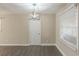 Dining area features attractive flooring, modern light fixture, and a bright window at 858 Commodore Nw Dr, Atlanta, GA 30318
