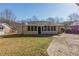 Exterior view featuring a well-maintained lawn and a covered porch accessible via a concrete walkway at 858 Commodore Nw Dr, Atlanta, GA 30318