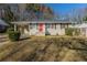 Charming ranch-style home featuring a bright red front door and a convenient covered carport at 858 Commodore Nw Dr, Atlanta, GA 30318