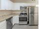 This kitchen features white cabinets, granite countertops, and modern stainless steel appliances at 858 Commodore Nw Dr, Atlanta, GA 30318