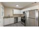 Modern kitchen features granite counters, stainless steel appliances, white cabinets, and stylish flooring at 858 Commodore Nw Dr, Atlanta, GA 30318