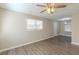 Spacious living room with wood-look floors, a ceiling fan, and plenty of natural light at 858 Commodore Nw Dr, Atlanta, GA 30318