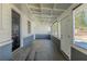 Sunroom featuring a concrete floor, white trim, and an abundance of windows at 858 Commodore Nw Dr, Atlanta, GA 30318