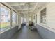 Sunroom featuring a concrete floor, white trim, and an abundance of windows at 858 Commodore Nw Dr, Atlanta, GA 30318