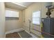 Modest utility room with water heater, storage cabinet, and neutral-toned walls at 858 Commodore Nw Dr, Atlanta, GA 30318