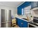 Updated kitchen featuring stainless steel refrigerator and bright blue cabinets at 105 Huskins Rd, Canton, GA 30115