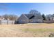 Back of home featuring gray siding, windows, concrete patio, and a fenced yard at 1270 Platinum Dr, Hoschton, GA 30548