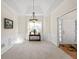 Bright dining room with large window, wainscoting, and decorative chandelier at 1270 Platinum Dr, Hoschton, GA 30548