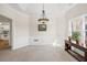 Bright dining room featuring wainscoting, a window, and access to the kitchen at 1270 Platinum Dr, Hoschton, GA 30548