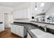 Kitchen showcasing granite countertops, white cabinetry, and a seamless transition to the living room at 1270 Platinum Dr, Hoschton, GA 30548