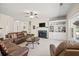 Bright living room featuring a marble fireplace, built-in shelving, and plush leather furniture at 1270 Platinum Dr, Hoschton, GA 30548