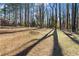 A large backyard featuring a combination of trees, sunlight, and expansive grassy areas at 2746 Hedgewood Nw Dr, Atlanta, GA 30311