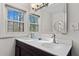 Bright bathroom features a dual sink vanity, modern fixtures, and a large window with a scenic outdoor view at 2746 Hedgewood Nw Dr, Atlanta, GA 30311