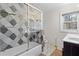 Well-lit bathroom featuring patterned tile flooring and a shower/tub combo at 2746 Hedgewood Nw Dr, Atlanta, GA 30311