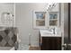 Bathroom with shower/tub combination with patterned tile and stylish vanity at 2746 Hedgewood Nw Dr, Atlanta, GA 30311