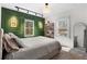 Comfortable bedroom featuring stylish green accent wall and natural light at 2746 Hedgewood Nw Dr, Atlanta, GA 30311