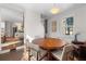 Bright dining area featuring a round wooden table and views into the living room at 2746 Hedgewood Nw Dr, Atlanta, GA 30311