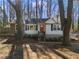 Charming single-Gathering home with cedar shingles, white siding, dark trim, and a welcoming red front door at 2746 Hedgewood Nw Dr, Atlanta, GA 30311