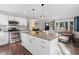 Open kitchen featuring stainless steel appliances, white cabinets, an island, and views to the living area at 2746 Hedgewood Nw Dr, Atlanta, GA 30311