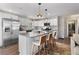 Bright kitchen with white cabinets, an island, stainless appliances, and views to the living area at 2746 Hedgewood Nw Dr, Atlanta, GA 30311