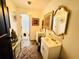 Well-lit bathroom with double vanity and decorative mirrors at 4665 Guilford Forest Sw Dr, Atlanta, GA 30331