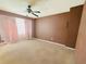 Carpeted bedroom with light walls, large window, and ceiling fan at 4665 Guilford Forest Sw Dr, Atlanta, GA 30331