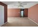 Spacious bedroom featuring a ceiling fan and neutral carpeting for a cozy atmosphere at 4665 Guilford Forest Sw Dr, Atlanta, GA 30331