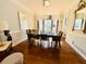 Well-lit dining room with hardwood floors, large window, and modern chandelier at 4665 Guilford Forest Sw Dr, Atlanta, GA 30331