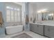 Bright bathroom with white marble floors, quartz countertops and free standing bathtub at 47 Cuthbert Ln Ne, Acworth, GA 30101