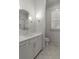 Bright bathroom featuring a vanity with modern fixtures, an octagonal mirror, and plantation shutters at 47 Cuthbert Ln Ne, Acworth, GA 30101