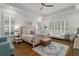 Large bedroom with wood floors, tray ceiling, ceiling fan and bright windows with white shutters at 47 Cuthbert Ln Ne, Acworth, GA 30101