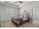 Bright bedroom with tray ceiling, plantation shutters, and view into ensuite bath with patterned tile floors at 47 Cuthbert Ln Ne, Acworth, GA 30101