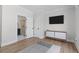 Modern bedroom with wood flooring, contemporary dresser, and ensuite bathroom access at 47 Cuthbert Ln Ne, Acworth, GA 30101