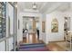 Grand foyer with hardwood floors, a view to the open-concept living spaces, and a colorful accent rug at 47 Cuthbert Ln Ne, Acworth, GA 30101