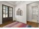 Inviting foyer with dark wood floors, colorful rug, and decorative wall art, flowing into the home at 47 Cuthbert Ln Ne, Acworth, GA 30101