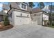 Spacious three-car garage with white doors and dark accents at 47 Cuthbert Ln Ne, Acworth, GA 30101