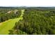 Scenic aerial view of a golf course winding through lush greenery with a residential community nearby at 47 Cuthbert Ln Ne, Acworth, GA 30101