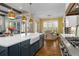 Open kitchen featuring an island with a sink, stainless steel appliances, and an adjacent dining area with hardwood floors at 47 Cuthbert Ln Ne, Acworth, GA 30101