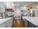 Bright kitchen featuring stainless steel appliances, quartz countertops, farmhouse sink, and view into dining area at 47 Cuthbert Ln Ne, Acworth, GA 30101