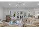 Bright living room with modern ceiling fan, hardwood floors, and access to an outdoor living space at 47 Cuthbert Ln Ne, Acworth, GA 30101