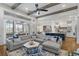 Open-concept living room with hardwood floors, a cozy fireplace, and seamless access to the kitchen and screened porch at 47 Cuthbert Ln Ne, Acworth, GA 30101