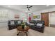 Cozy living room features dual leather sofas, a ceiling fan, shutters and a rustic sliding barn door at 47 Cuthbert Ln Ne, Acworth, GA 30101