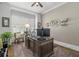 Comfortable home office with ceiling fan, plantation shutters, and large wooden desk workspace at 47 Cuthbert Ln Ne, Acworth, GA 30101