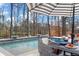 Outdoor pool area featuring dining table under umbrella and serene wooded backdrop at 47 Cuthbert Ln Ne, Acworth, GA 30101