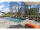 Beautiful backyard pool with travertine tile deck and landscaped surroundings at 47 Cuthbert Ln Ne, Acworth, GA 30101