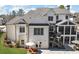 Rear view of a two-story home with a screened porch and a patio area for outdoor enjoyment at 47 Cuthbert Ln Ne, Acworth, GA 30101