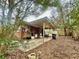 Cozy backyard featuring a covered patio, brick exterior, and mature trees surrounding the property at 2956 Cruse Rd, Lawrenceville, GA 30044