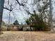 Charming red brick home with mature trees and landscaped front yard at 2956 Cruse Rd, Lawrenceville, GA 30044