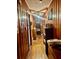 Hallway featuring wood paneling, ceiling fan, and decorative items at 2956 Cruse Rd, Lawrenceville, GA 30044